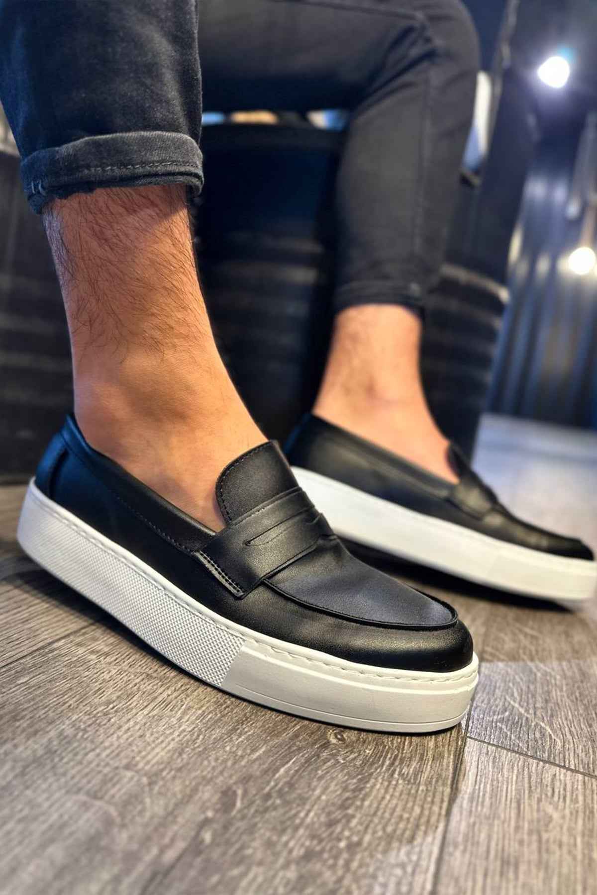Men's black loafers with white contrast sole and stitched apron detail