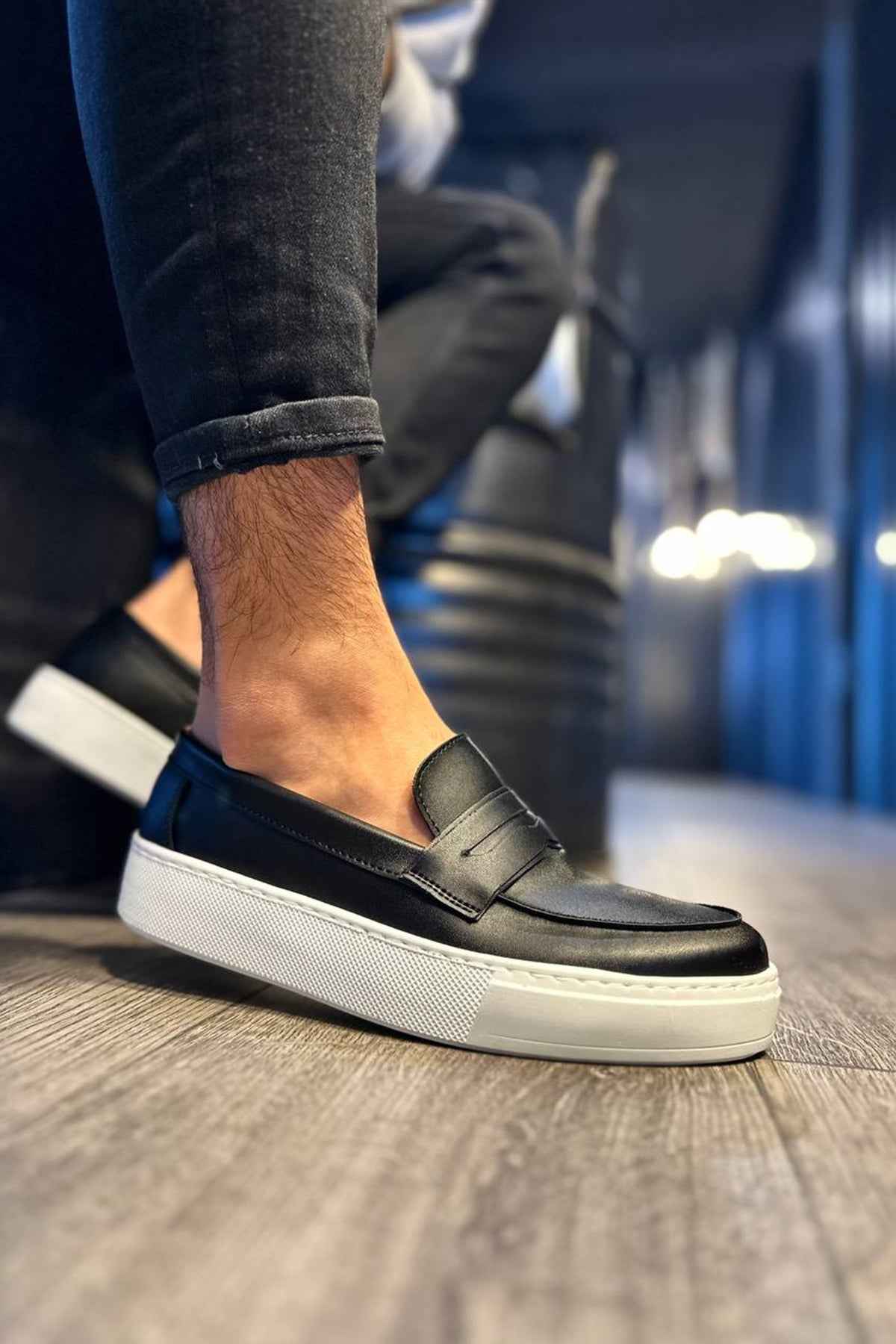 Men's black slip-on loafers with white sole and side seam detail