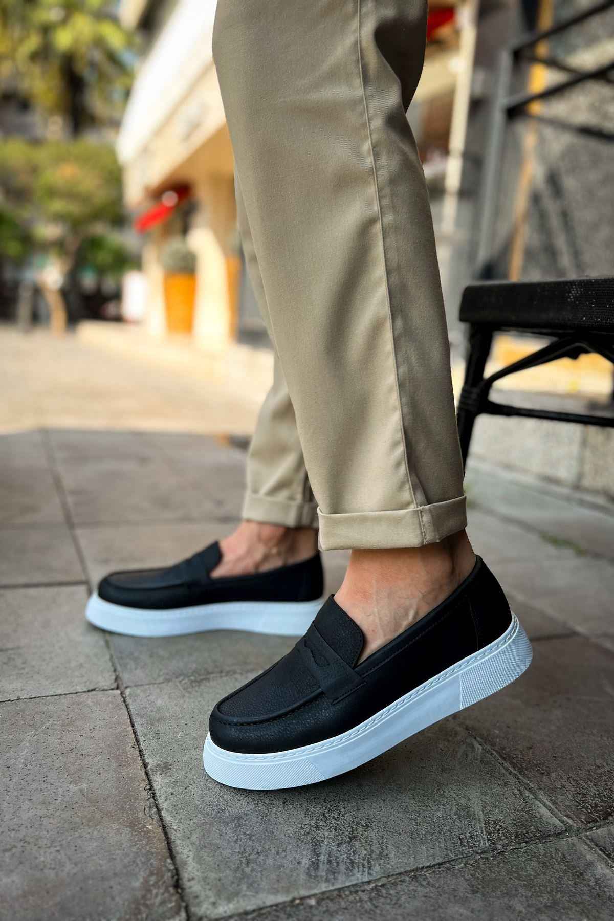 Men's black loafer slip-ons with white sidewall sole and low profile