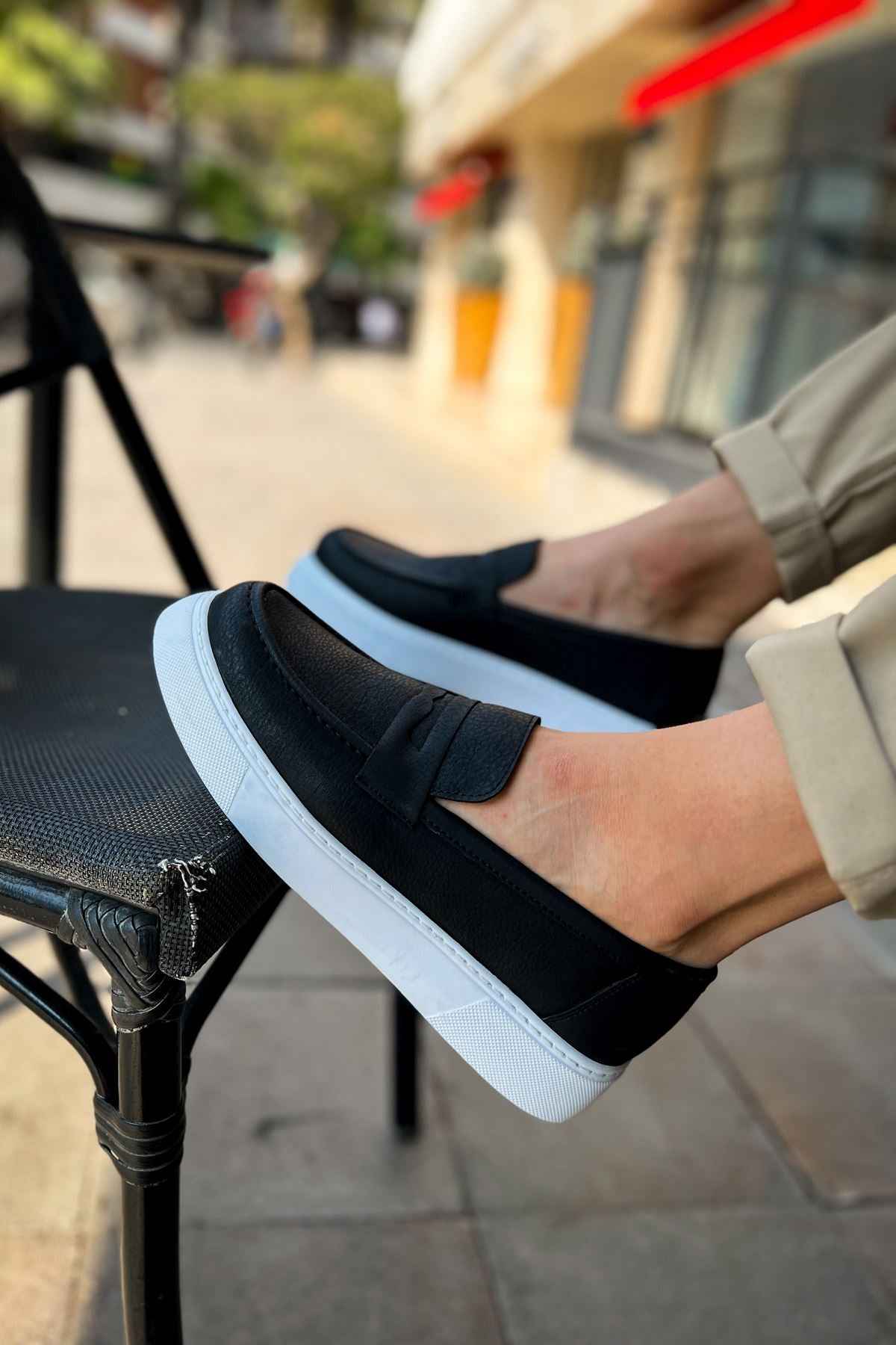 Men's black loafers with a wide band vamp and white rubber sole