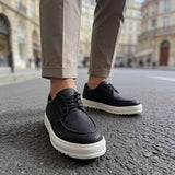 Men's black casual lace-up shoes with white sole, side front view