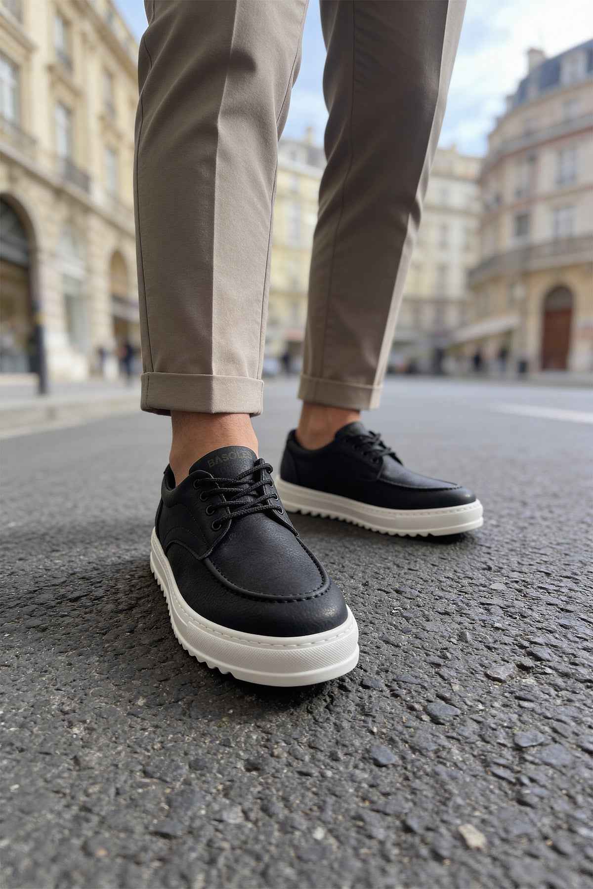 Men's black casual lace-up shoes with white sole, side front view