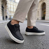 Men's black casual lace-up shoes with white sole, toe and side view