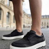 Men's black casual lace-up shoes with white sole, front angle view