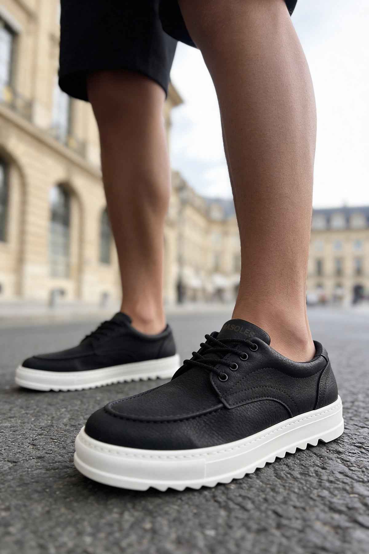 Men's black casual lace-up shoes with white sole, front angle view