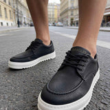 Men's black casual lace-up shoes with white sole, close toe view
