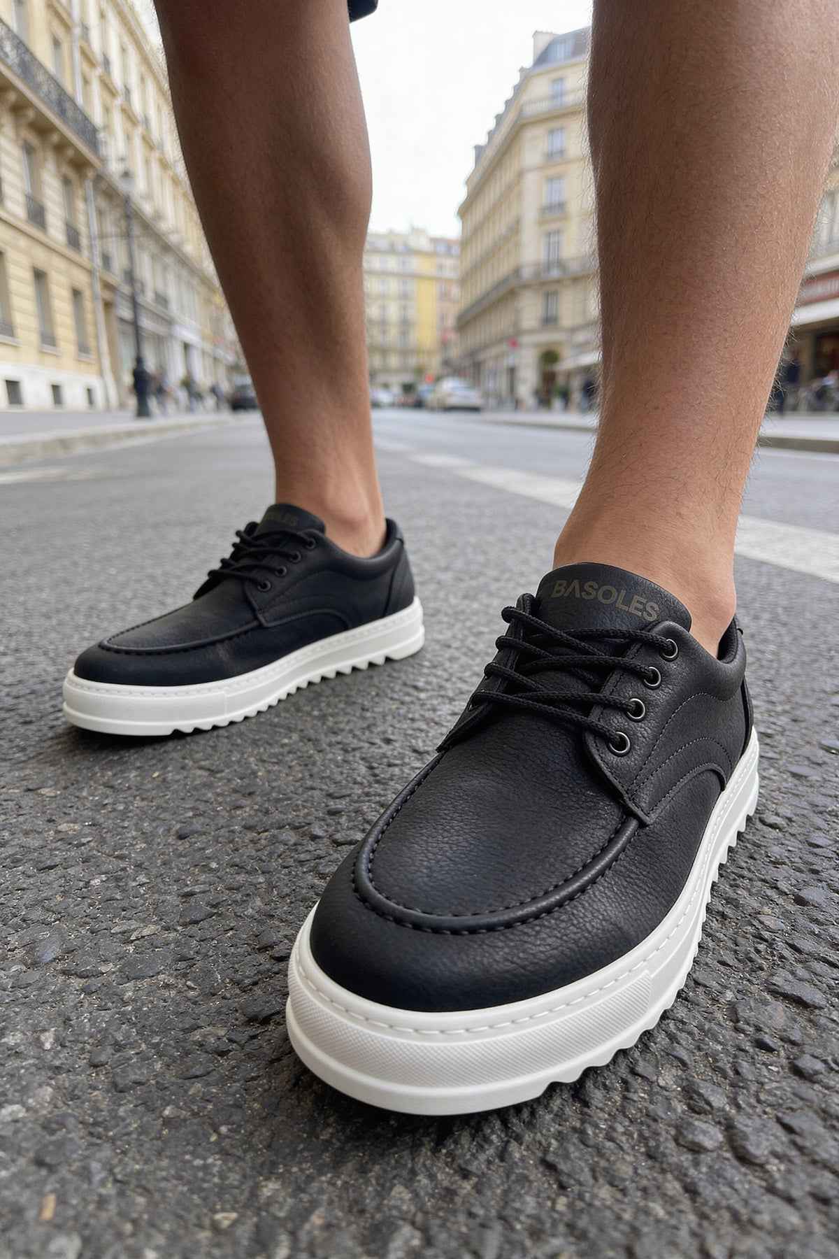 Men's black casual lace-up shoes with white sole, close toe view