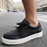 Men's black casual lace-up shoes with white sole, side close-up