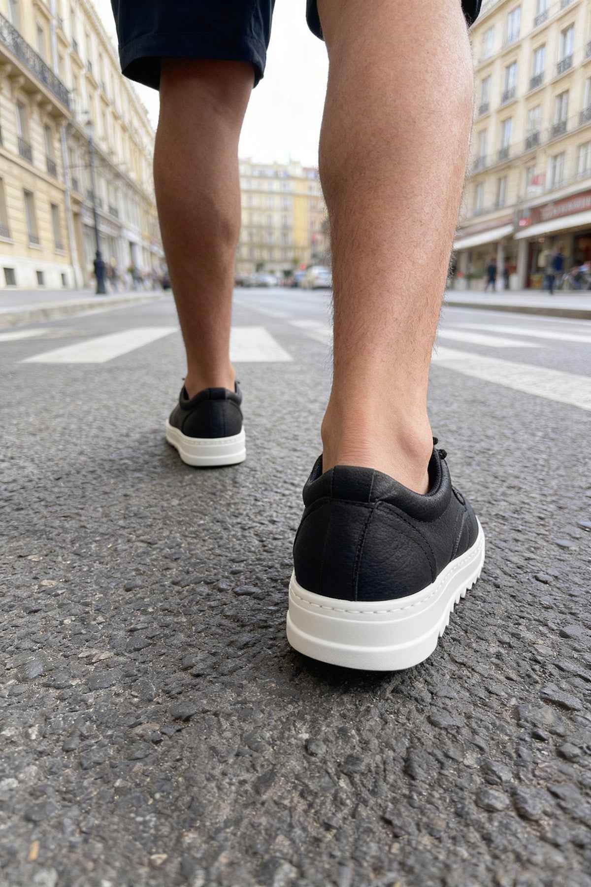 Men's black casual lace-up shoes with white rubber sole, rear view