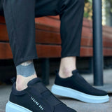 Black low-top sneakers with white sole and side logo text