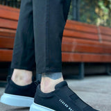 Black low-top sneakers, white outsole, side logo text