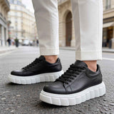 Black lace-up sneakers with white chunky sole and textured side panels