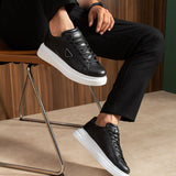 Black lace-up sneakers with white platform sole and side logo
