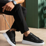 Black lace-up sneakers with white sole, side triangle logo