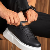 Black low-top lace-up sneakers with white sole and perforated toe