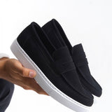 Men's black suede loafers with white rubber sole, slip-on style