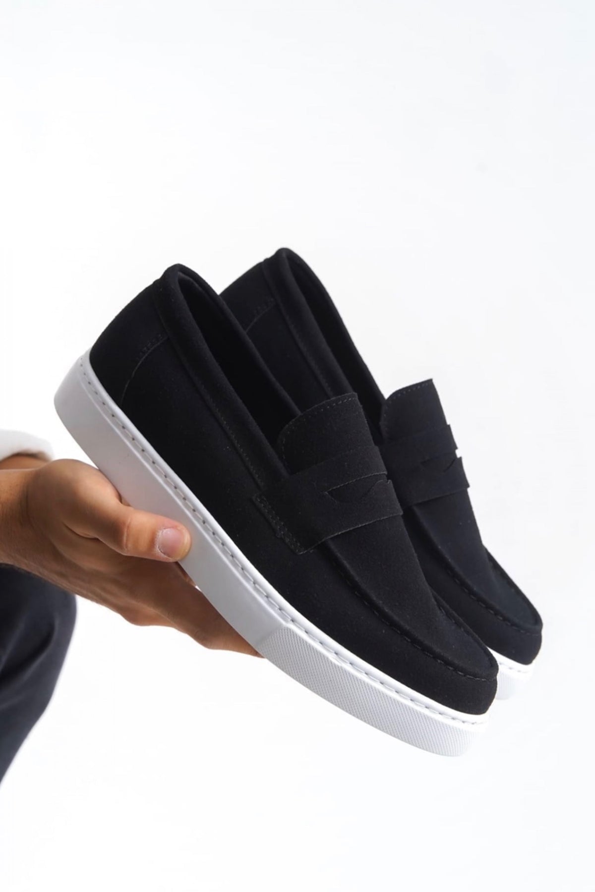 Men's black suede loafers with white rubber sole, slip-on style