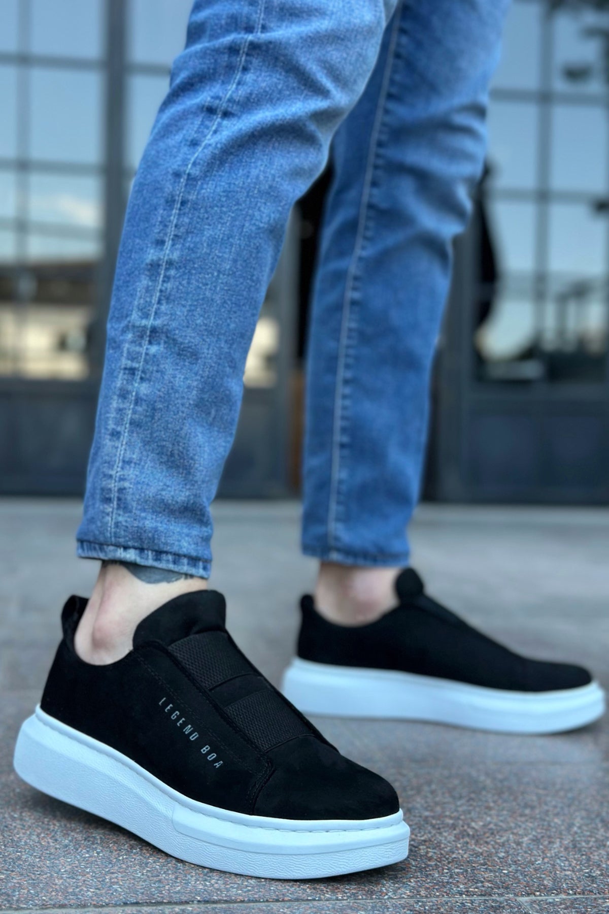 Men's black suede slip-on sneakers with white sole, rounded toe, low profile