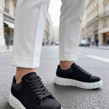 Black suede sneakers with lace-up vamp and white thick sole