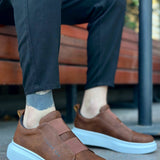 Brown slip-on casual sneakers with light blue sole and stitched detailing