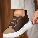 Brown casual sneakers with buckle strap and white midsole, side view