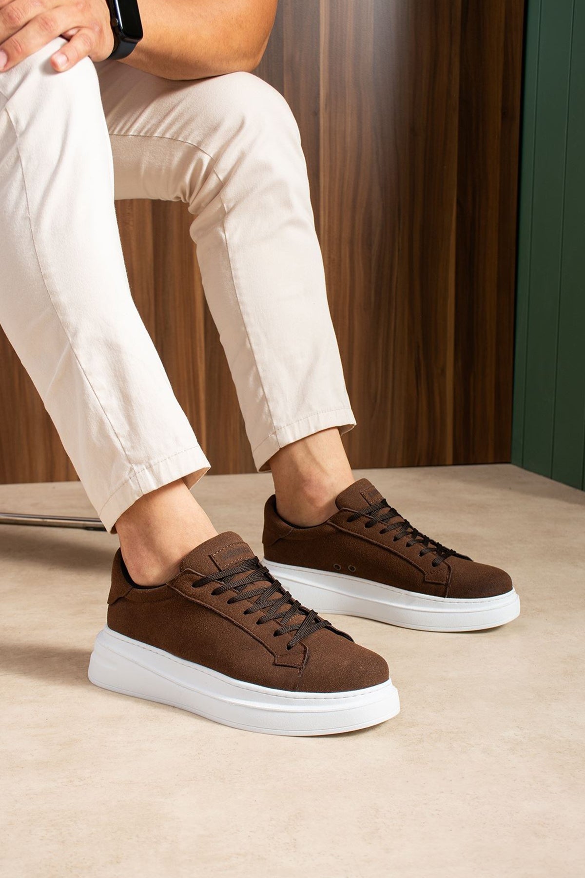 Men's brown suede sneakers on white sole, lace-up front and side angle