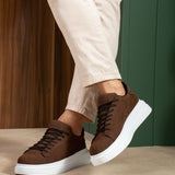 Men's brown suede sneakers with white midsole, low-top lace-up detail