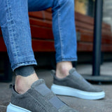 Gray suede slip-on sneakers with white rubber sole and side gore panels