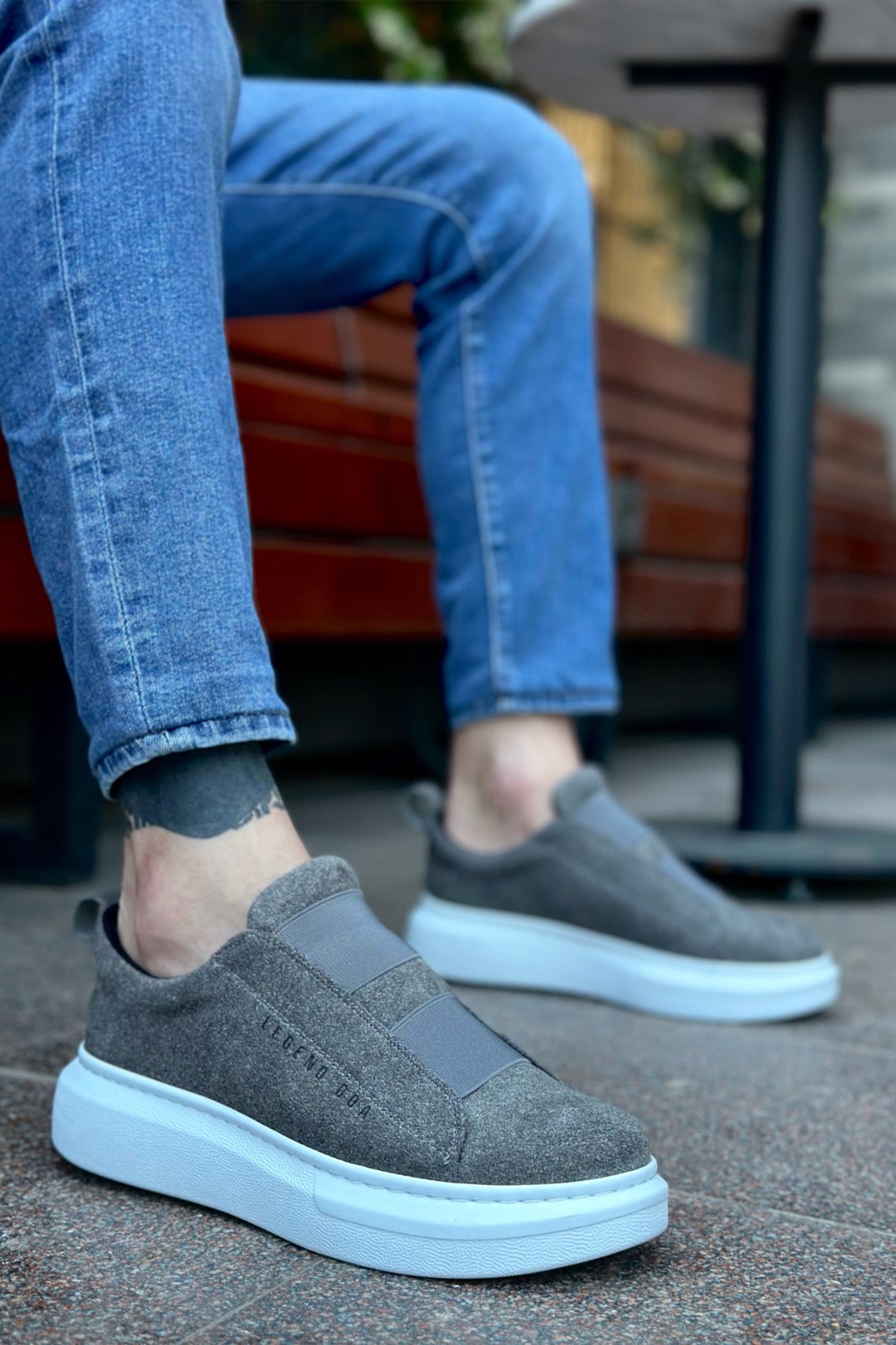 Gray suede slip-on sneakers with white rubber sole and side gore panels