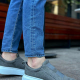 Gray suede sneakers with cushioned low sole and textured upper