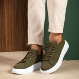 Men's olive suede low-top sneakers, lace-up pair with white sole, front angle