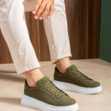 Men's olive suede low-top sneakers with white soles, lace-up, worn with cropped pants