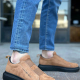 Men's tan suede slip-on sneakers with black rubber sole