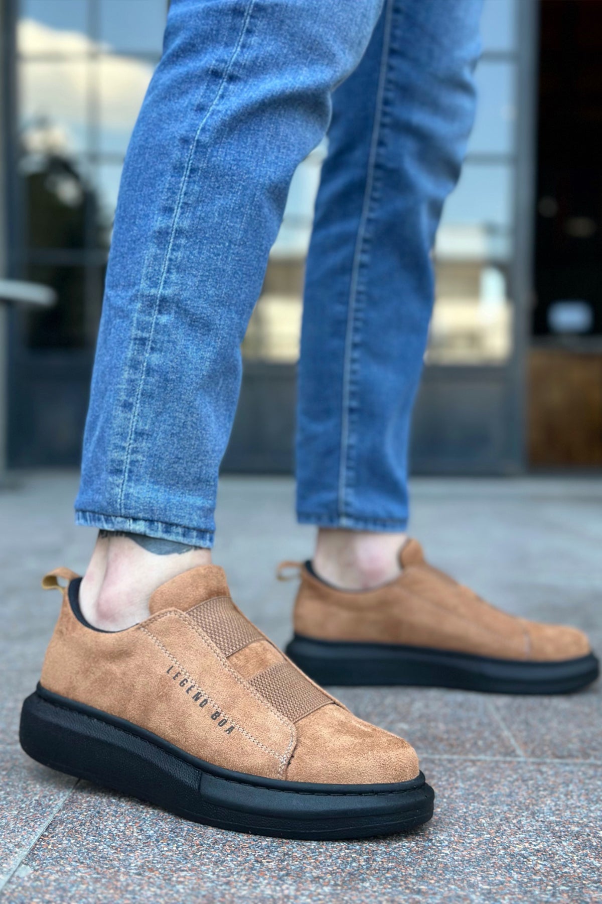 Men's tan suede slip-on sneakers with black rubber sole