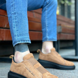 Tan suede slip-on sneakers, side view, black rubber sole