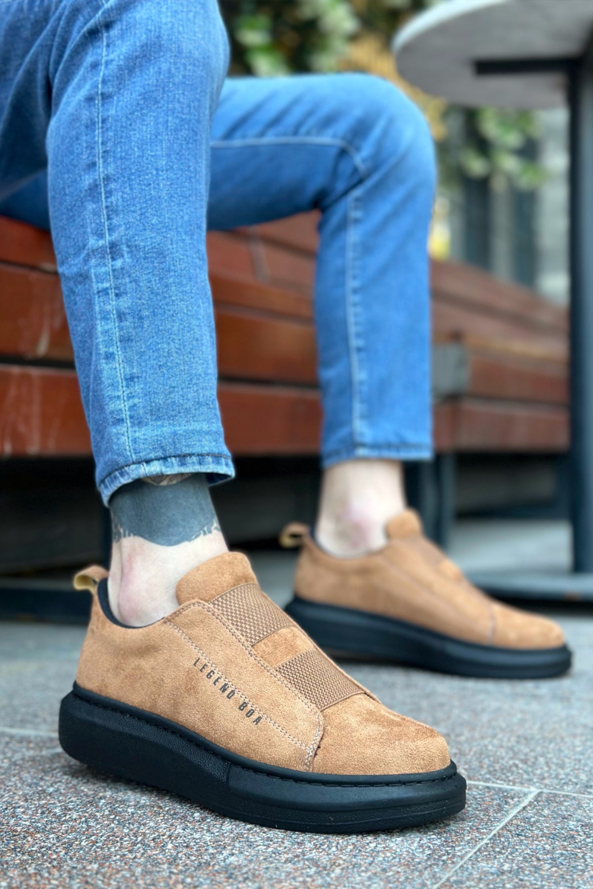 Tan suede slip-on sneakers, side view, black rubber sole
