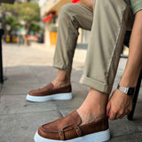 Men's tan loafers, side view, buckle strap with white rubber sole