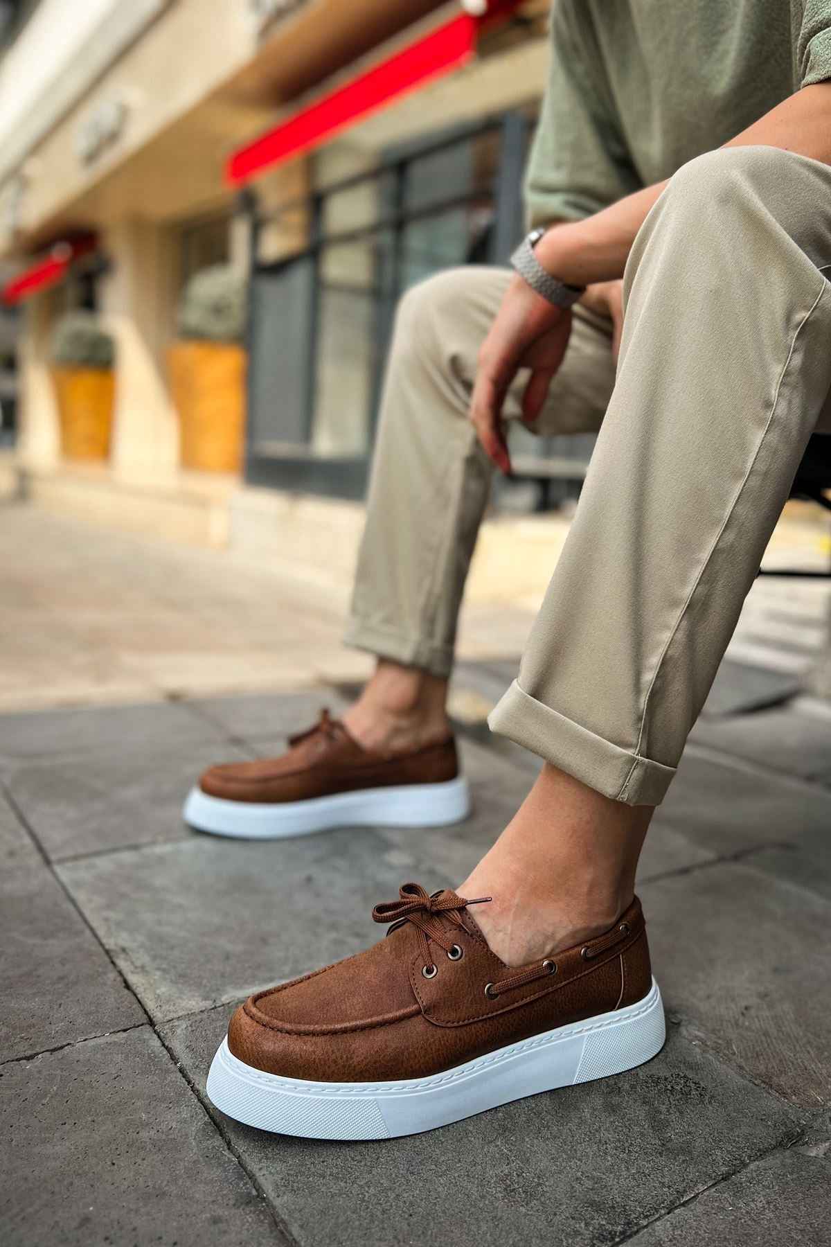 Tan lace-up casual shoes with brown upper and white platform sole