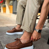 Tan lace-up casual shoes with brown upper, eyelets, and white platform sole