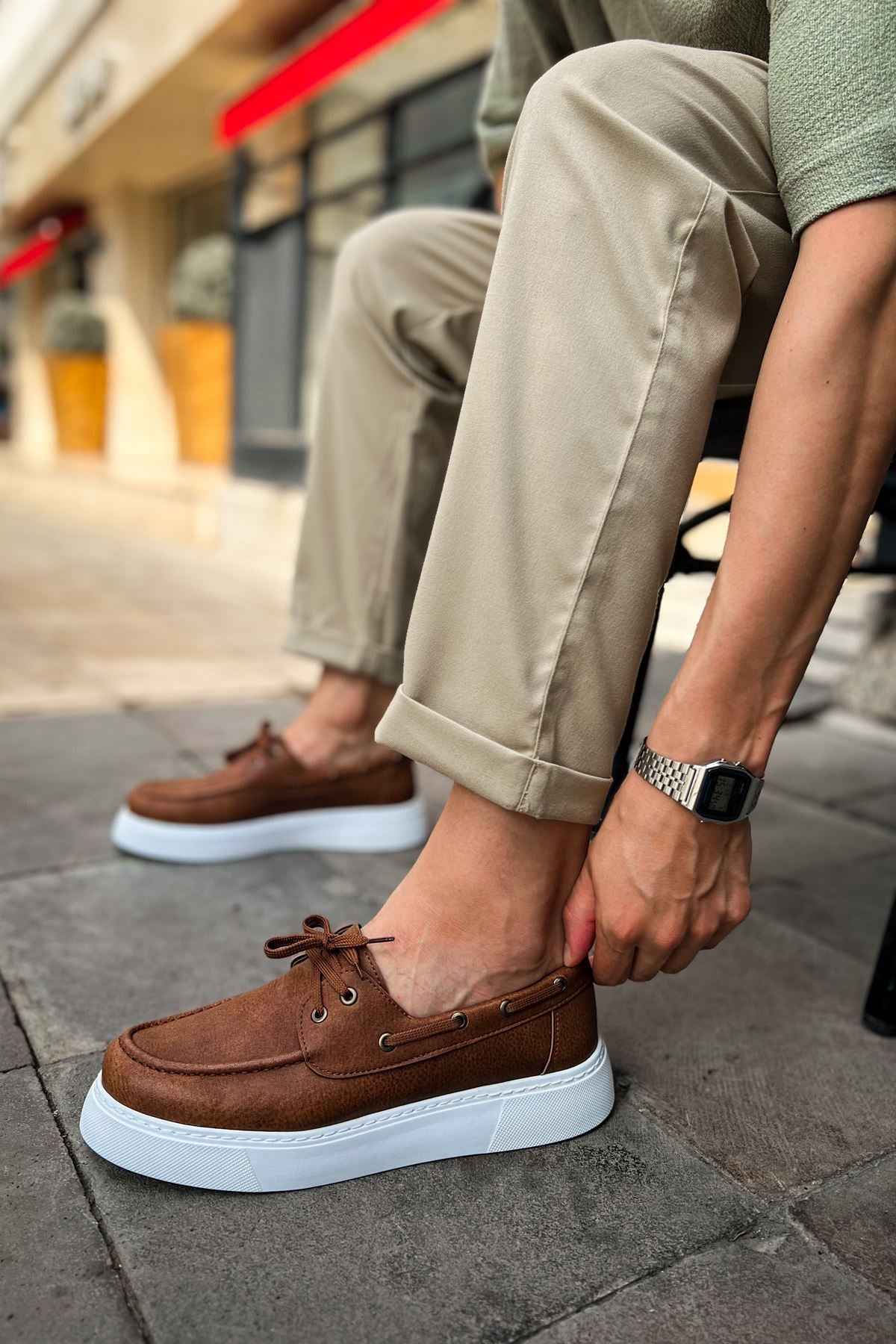 Tan lace-up casual shoes with brown upper, eyelets, and white platform sole