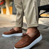 Tan lace-up casual shoes with brown upper and white platform sole, side view