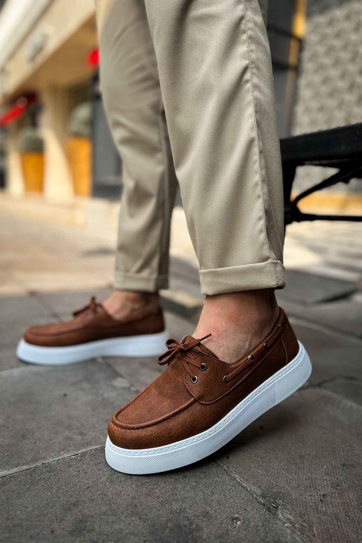 Tan lace-up casual shoes with brown upper and white platform sole, side view