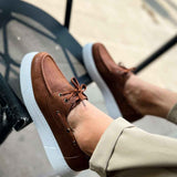 Tan lace-up casual shoe with brown laces and white platform sole edge