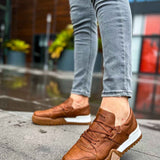 Men's tan casual sneakers with lace-up design and white sole, front angle