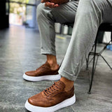 Tan casual sneakers with white rubber sole, lace-up design, low-top profile