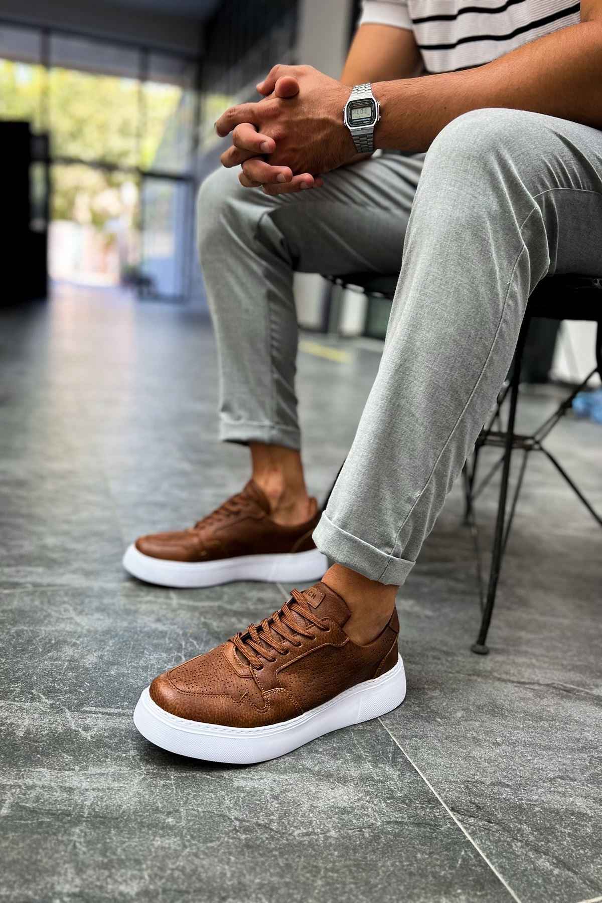 Tan casual sneakers with white rubber sole, lace-up design, low-top profile