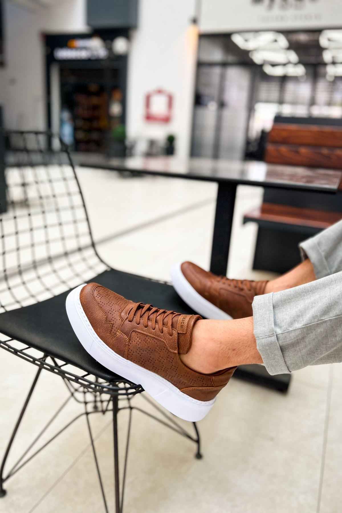 Tan low-top lace-up sneakers with white sole, side stitching texture
