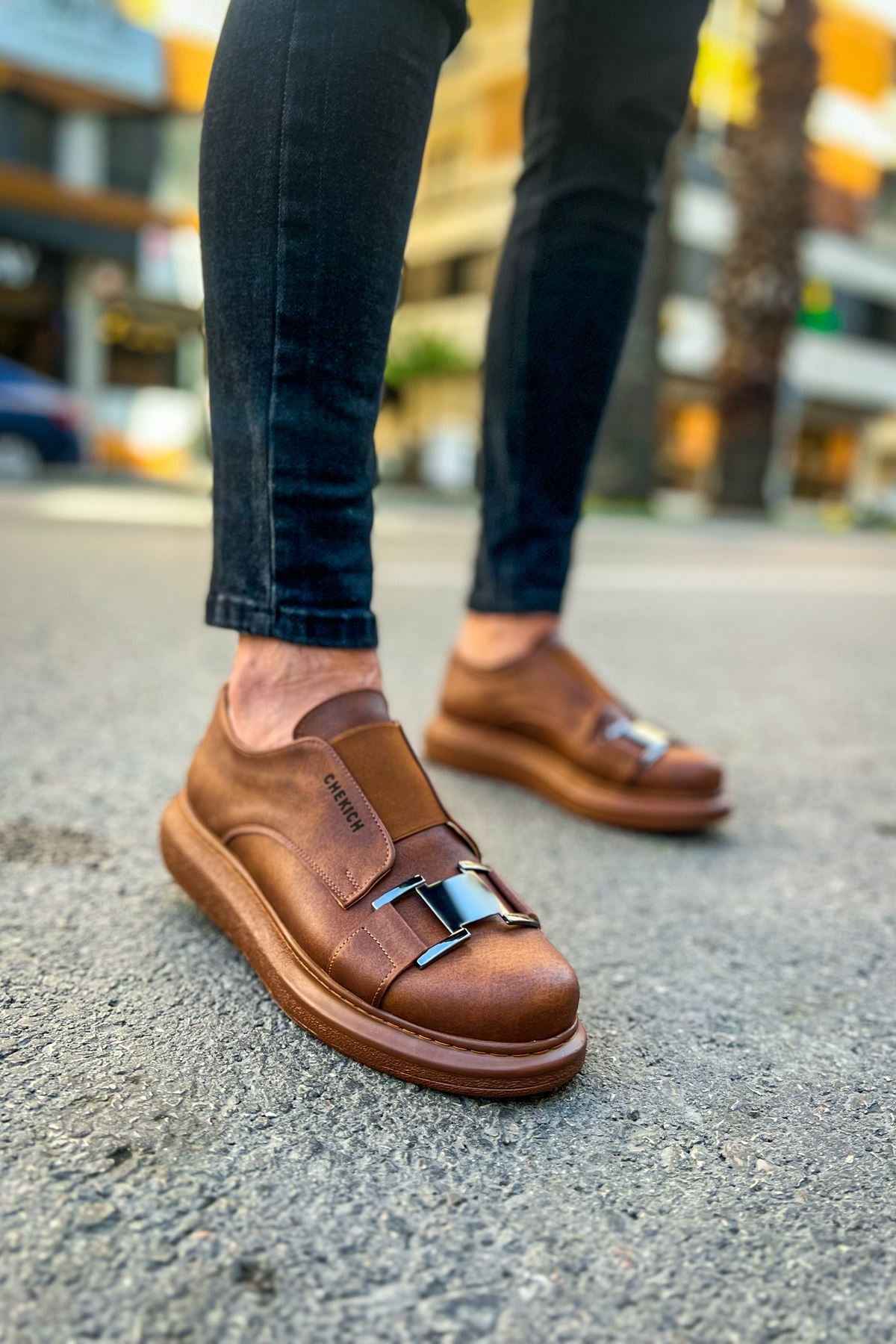 Tan casual sneakers with buckled straps and low-profile rubber sole