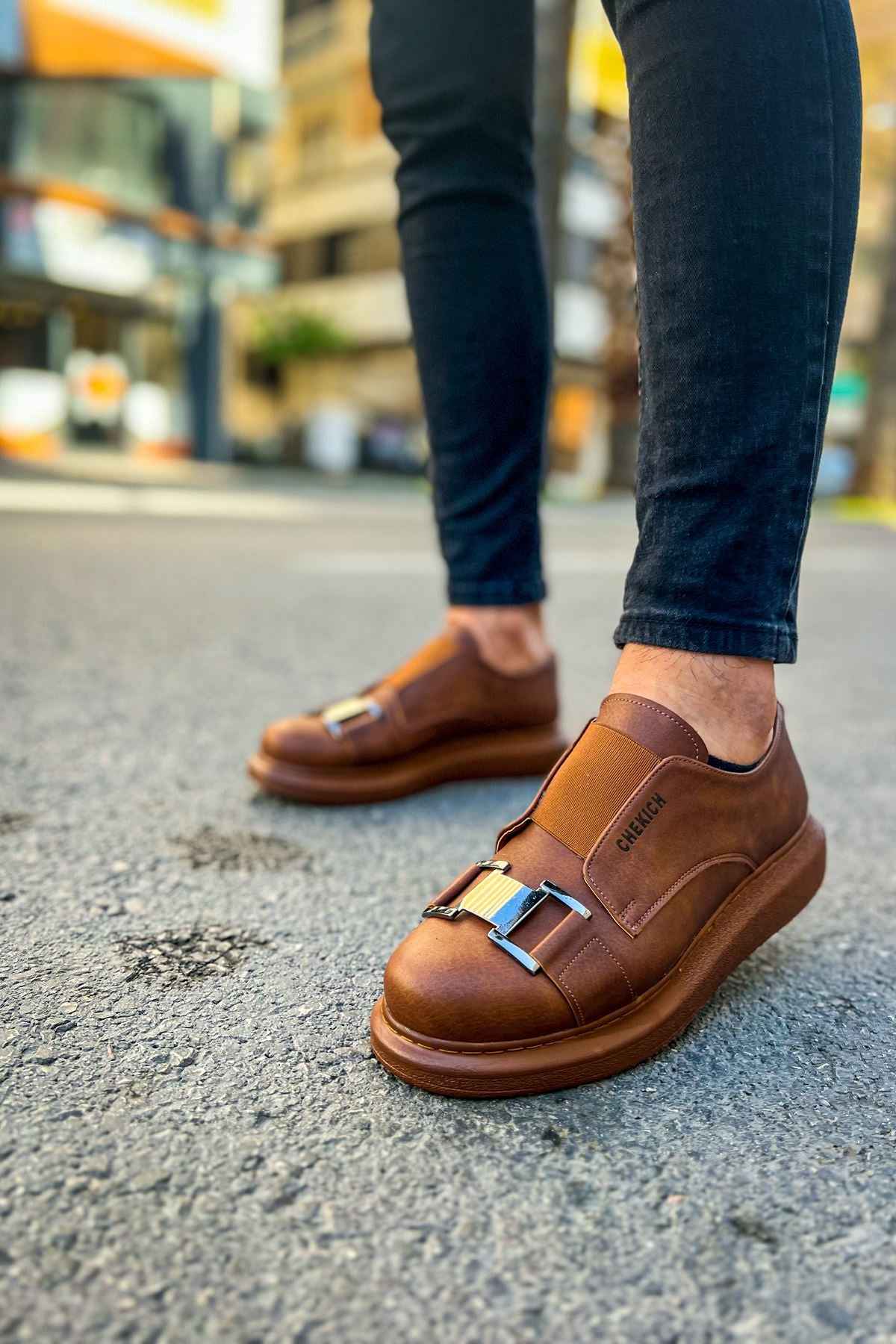 Tan casual sneakers, side view, buckled strap detail and padded collar