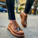 Tan casual sneakers, toe and vamp view, buckled strap across the upper